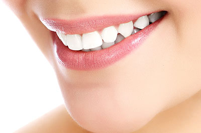 The image shows a close-up of a person s face with a focus on their teeth and lips, highlighting dental care and oral health.